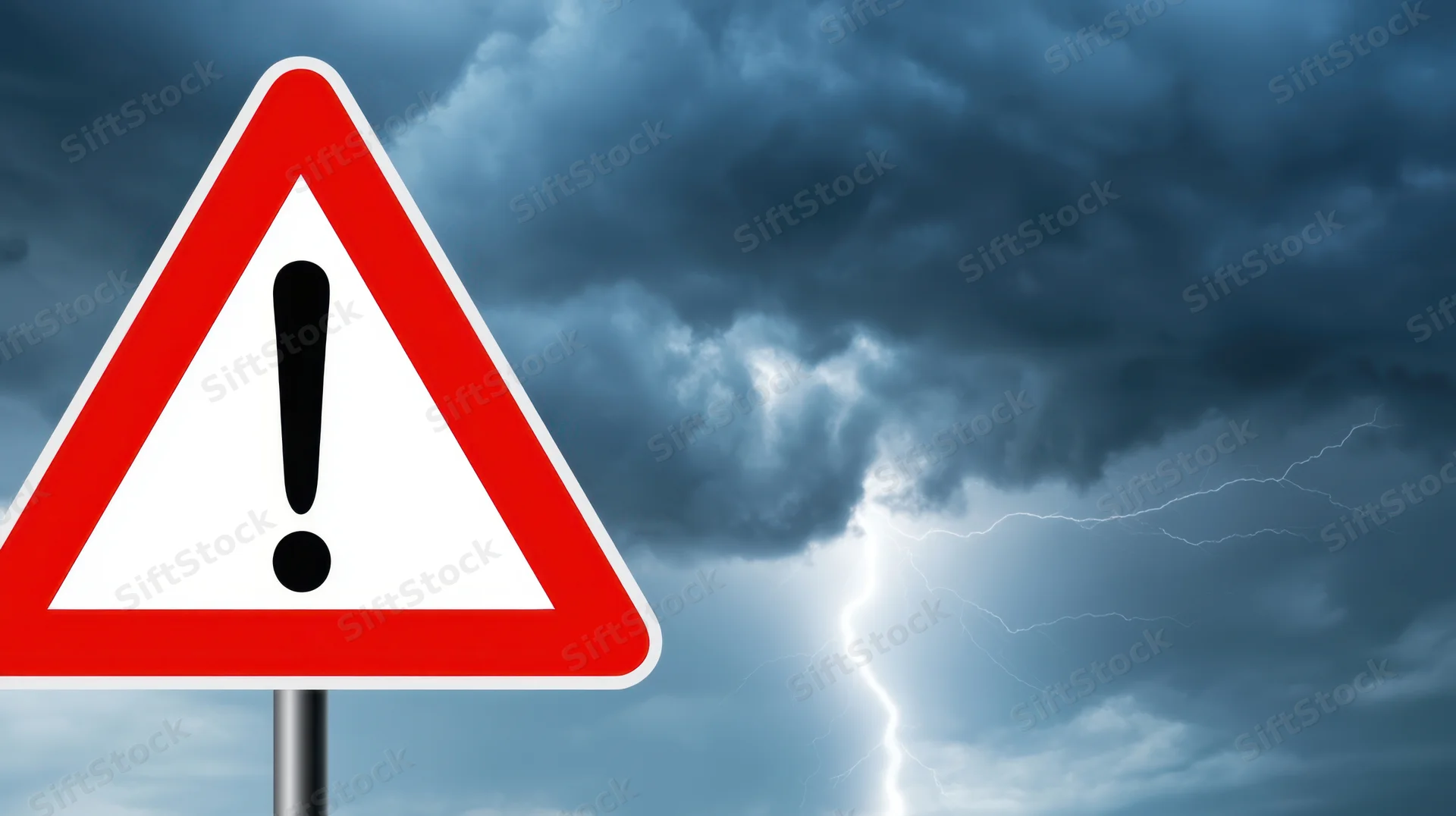 Red triangular warning sign with exclamation mark against stormy sky with lightning