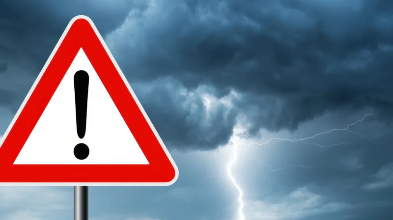 Red triangular warning sign with exclamation mark against stormy sky with lightning