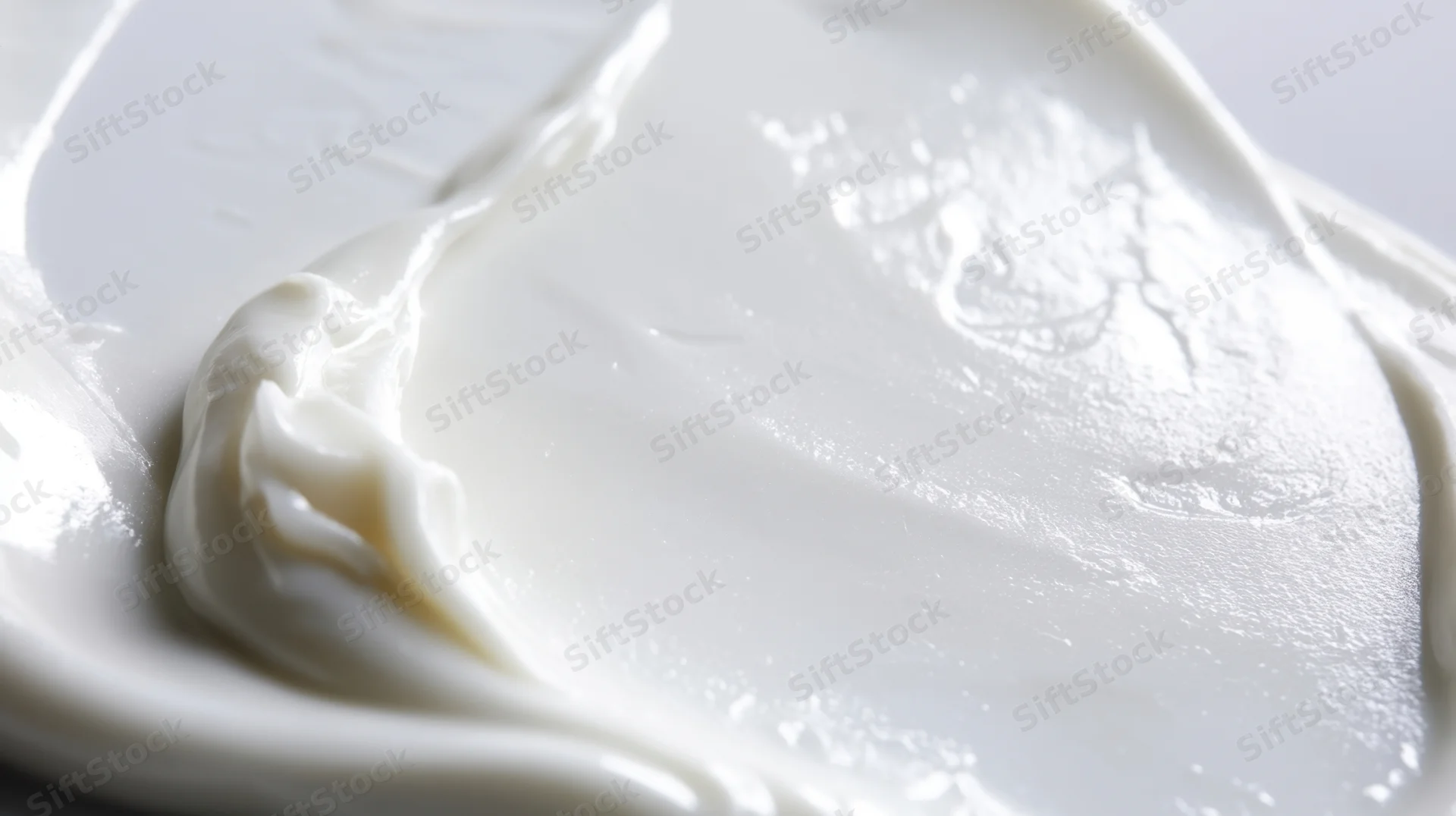 Smooth white cream spread on a plate, close-up view showing texture and sheen