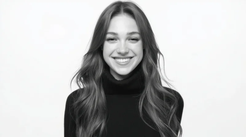 Smiling woman in black turtleneck against white background