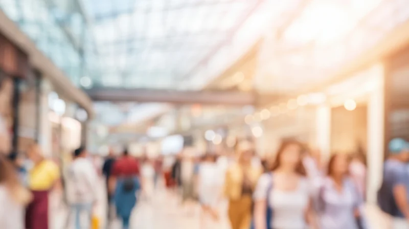 Blurred view of people walking through a shopping mall interior