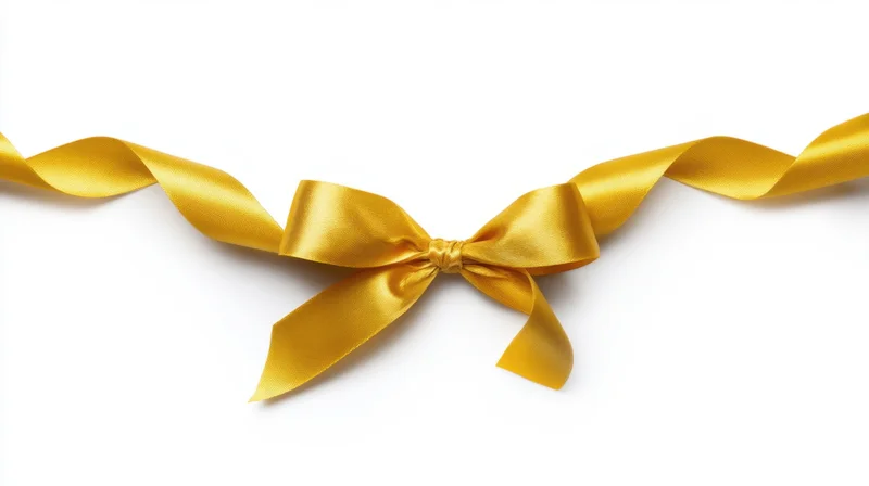 Golden satin ribbon tied in a bow on white background