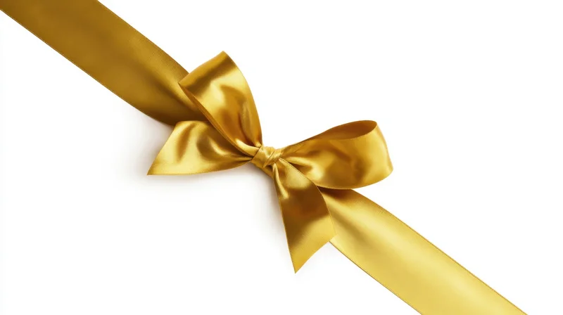 Golden satin ribbon tied in a bow on white background
