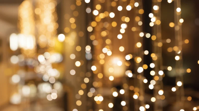 Blurred golden bokeh lights creating warm festive ambiance in interior space