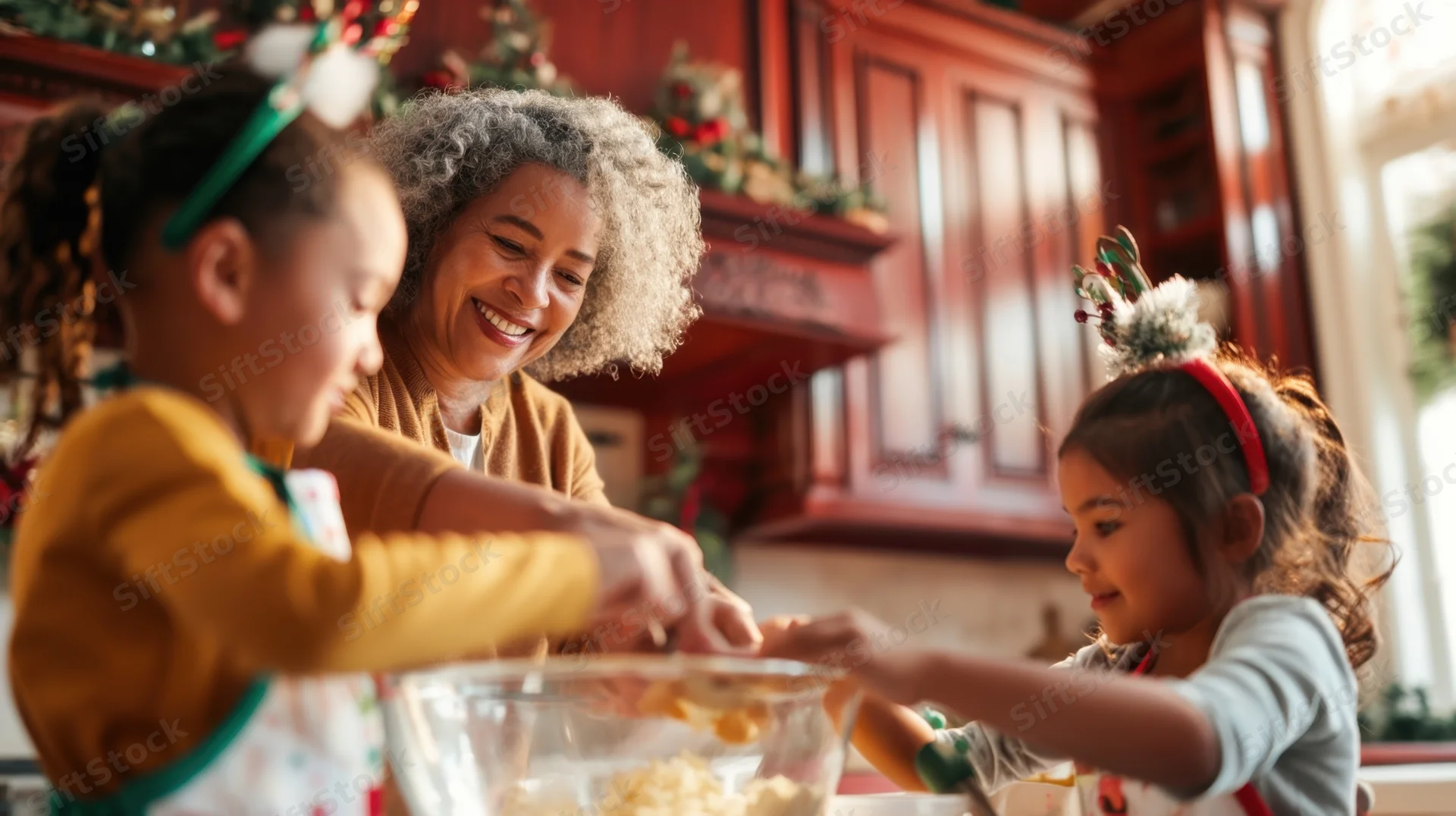 Grandmother and two granddaughters mixing dough in a decorated kitchen during christmas