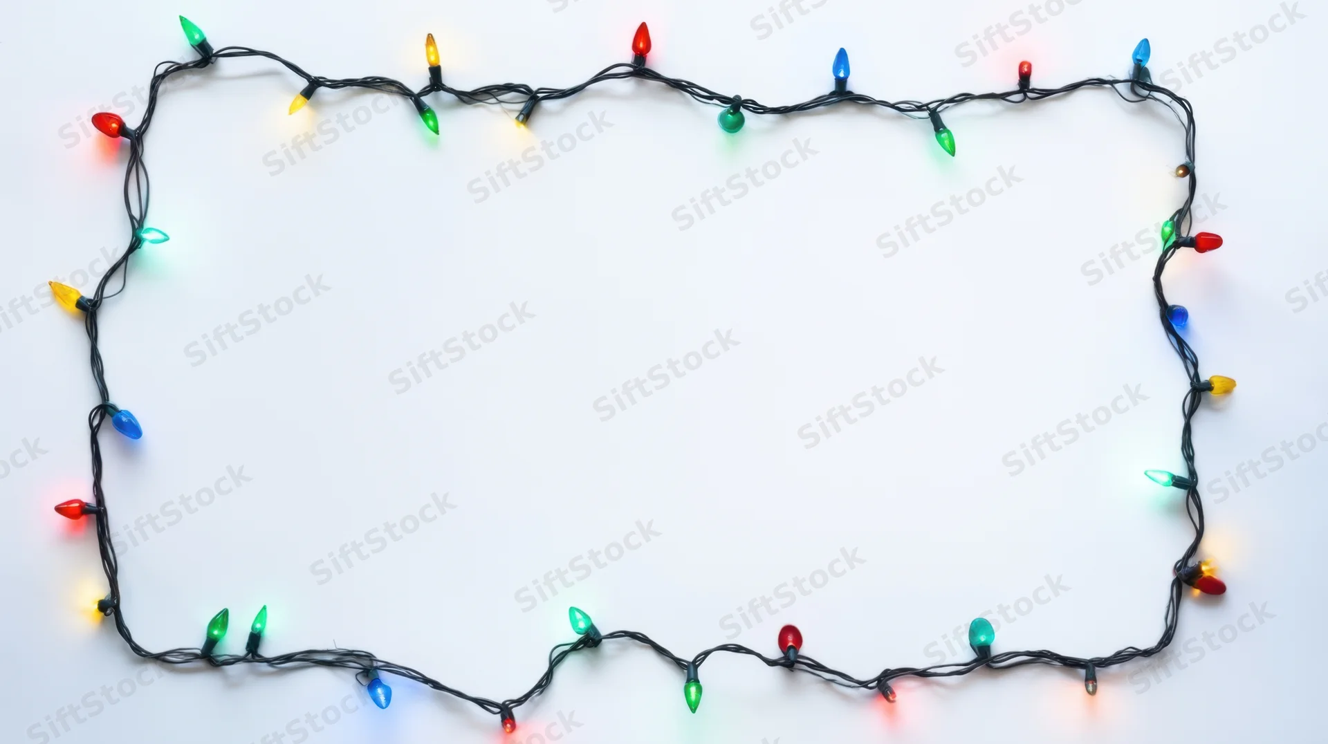 Colorful holiday string lights arranged in a rectangular frame on white background with copyspace