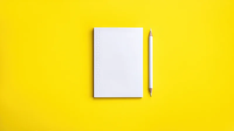 Blank notebook and pencil on yellow background with copyspace