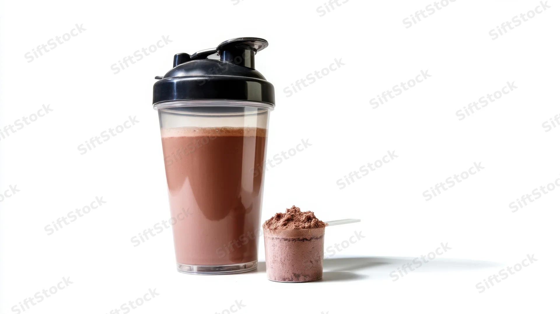 Chocolate protein shake in a transparent shaker bottle with powder scoop on white background