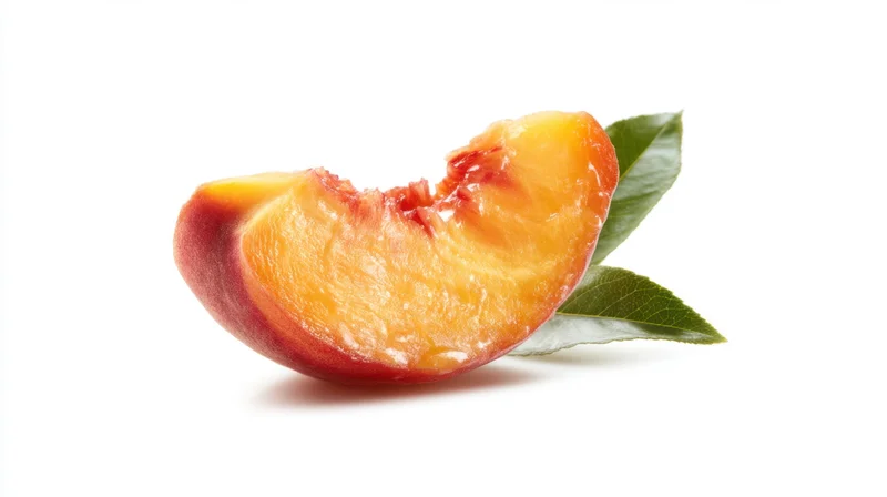 Slice of fresh peach with green leaf on white background