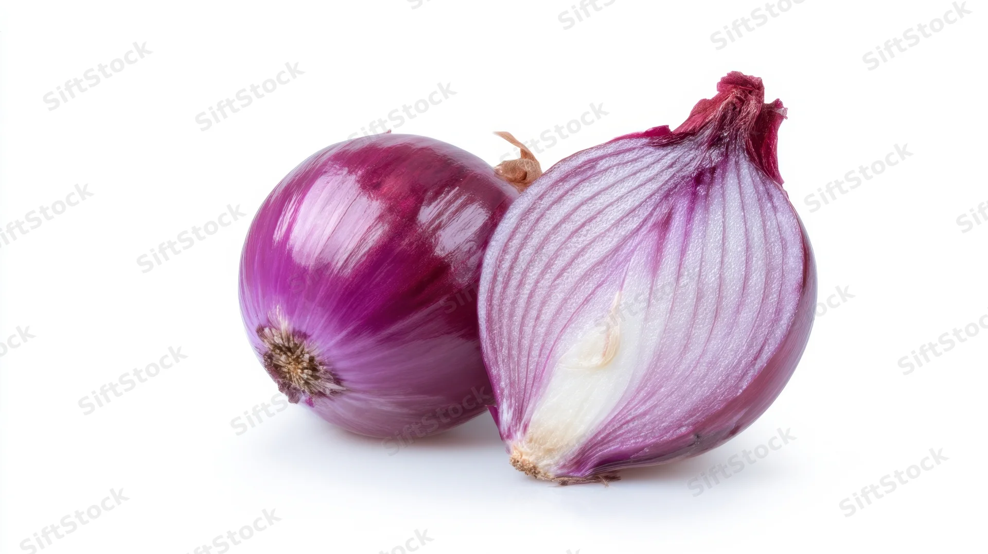 Two red onions, one whole and one halved, on a white background