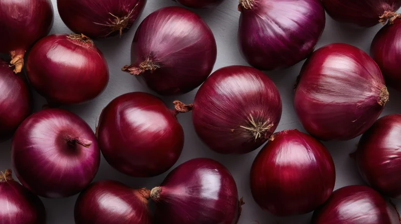 Red onions arranged in a flat lay on a gray surface