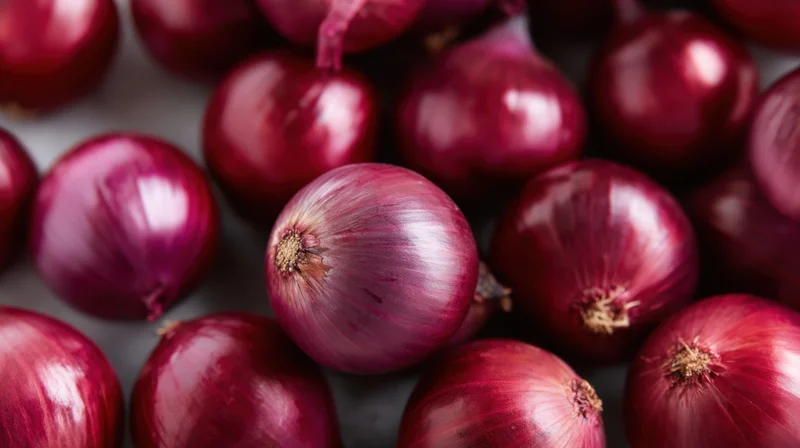 Closeup of fresh red onions arranged on a surface
