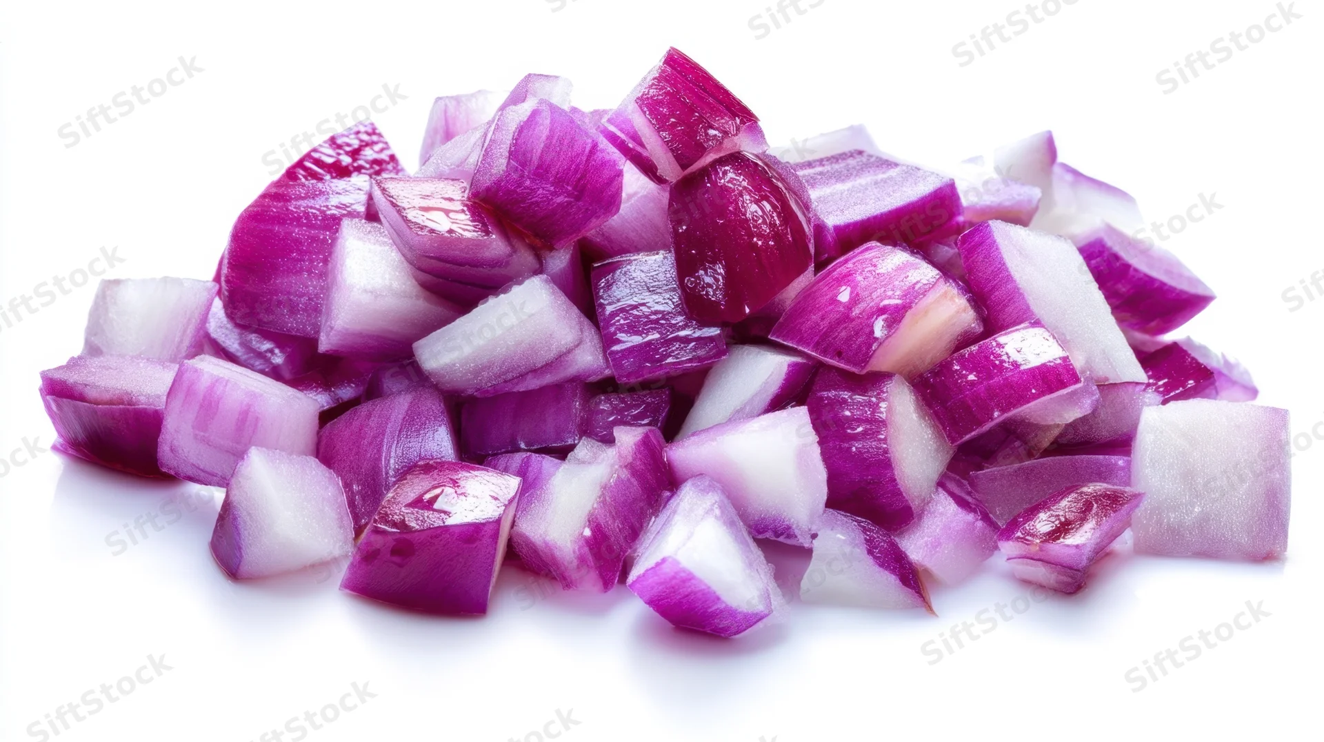 Diced red onions piled on a white surface