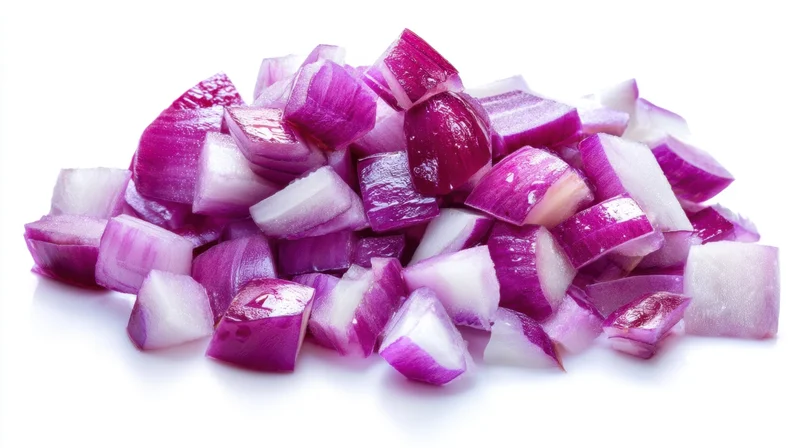 Diced red onions piled on a white surface
