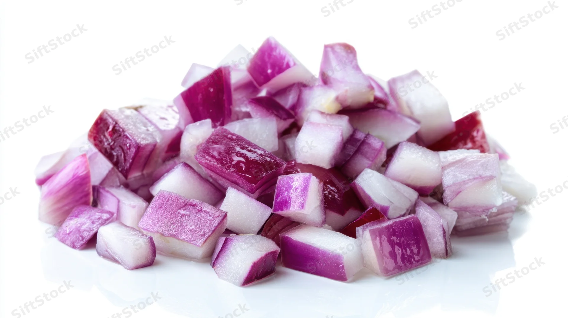 Diced red onions piled on a white surface