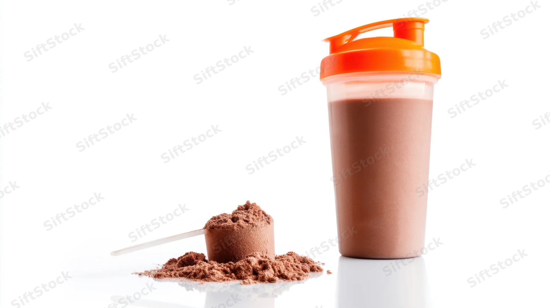 Protein powder scoop next to a chocolate shake in an orange shaker bottle on white background