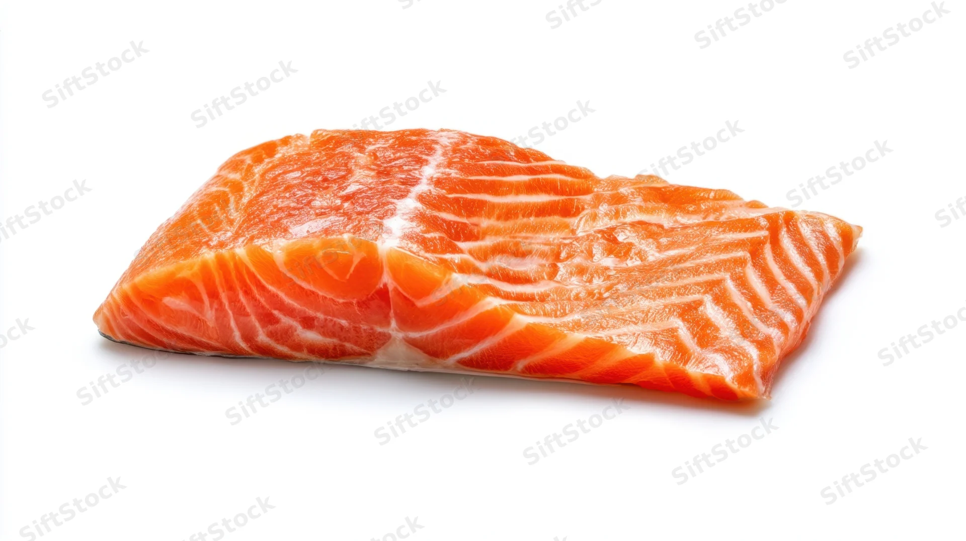 Raw salmon fillet with visible fat striations on white background