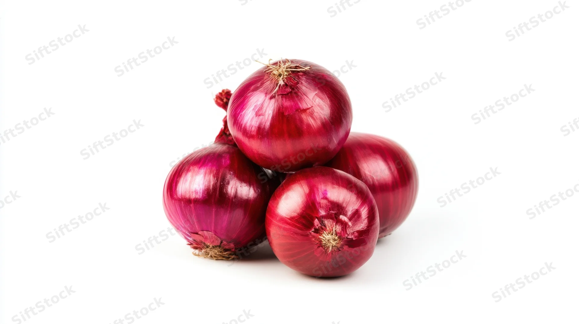 Four red onions stacked together on a white background
