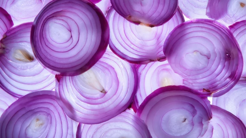 Sliced purple onions arranged in a flat lay closeup view