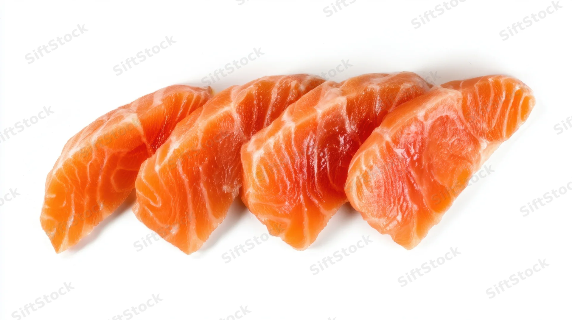 Four slices of raw salmon arranged in a row on a white background