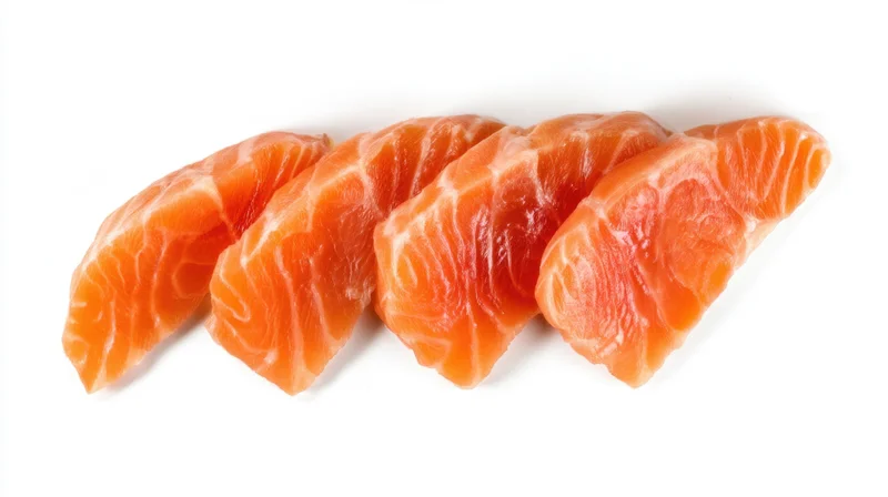 Four slices of raw salmon arranged in a row on a white background