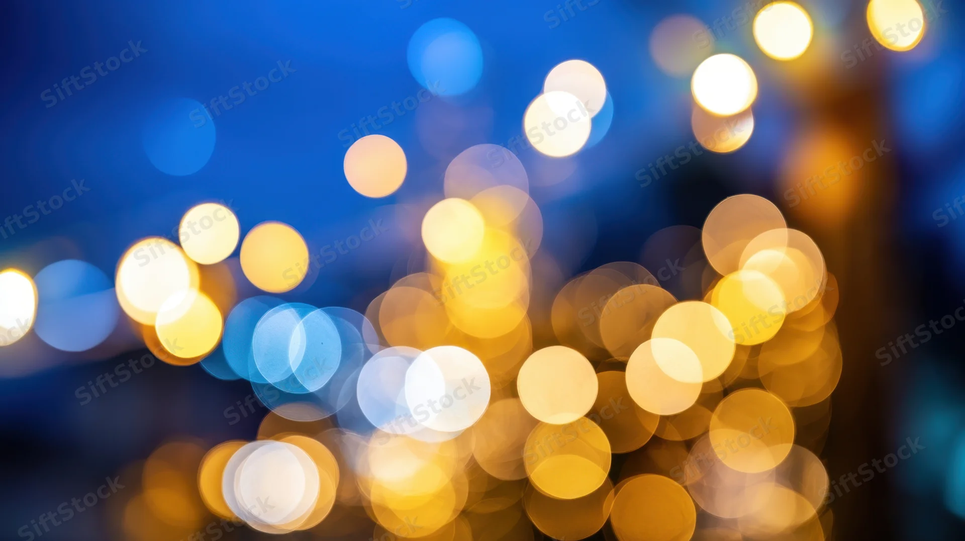 Blurred string lights glowing softly against a blue background at night