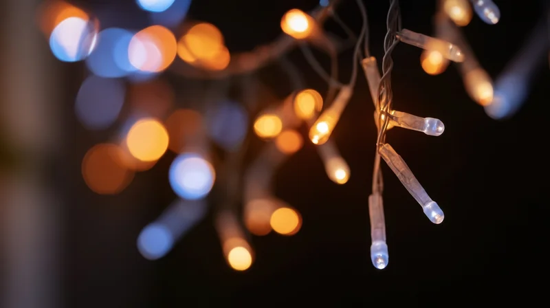 Close-up of colorful christmas fairy lights hanging with blurred bokeh background at night