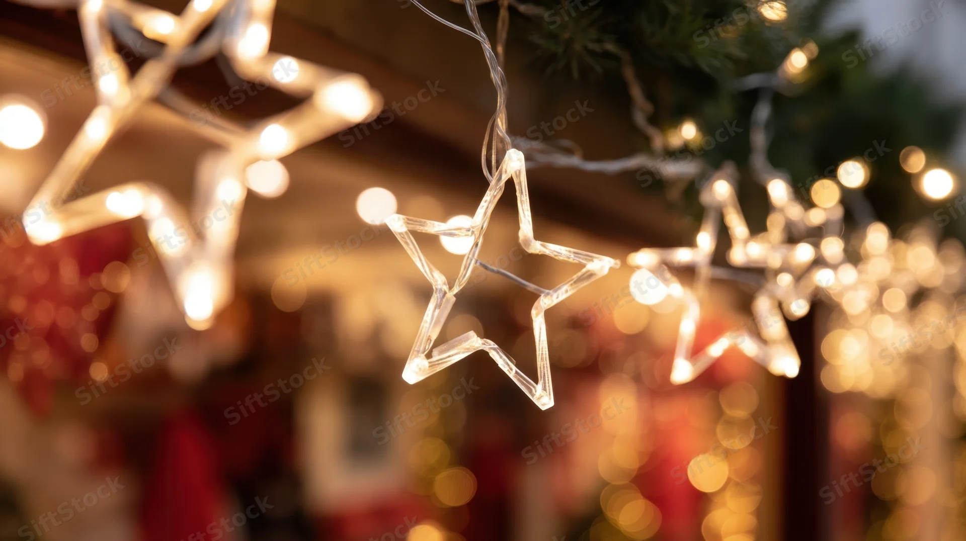 Star-shaped led lights glowing on a holiday decoration with blurred festive background