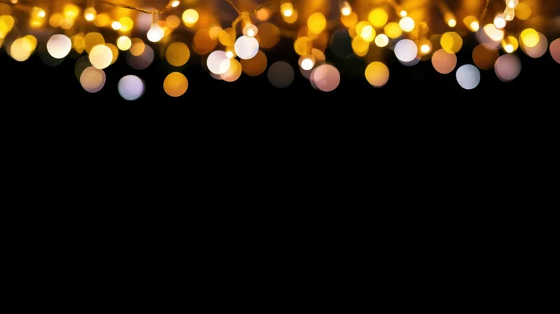 Decorative string lights glowing softly across the top of a black background with bokeh effect and copyspace below