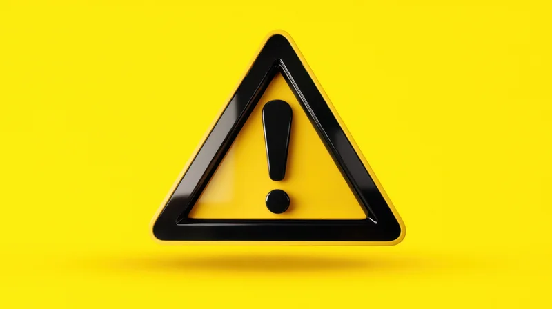 Yellow triangular warning sign with black exclamation mark on bright yellow background