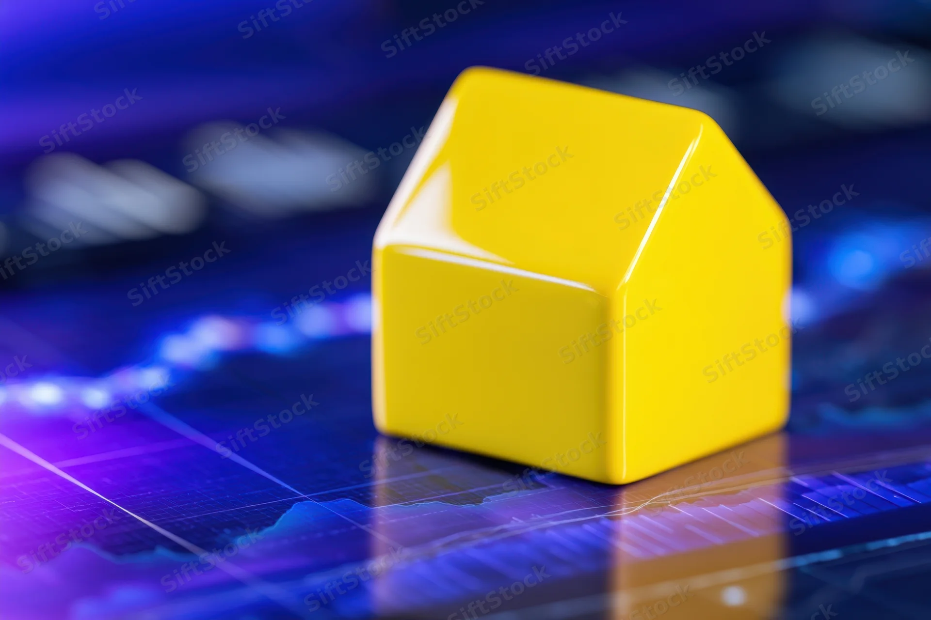 Yellow house model on digital financial graph display