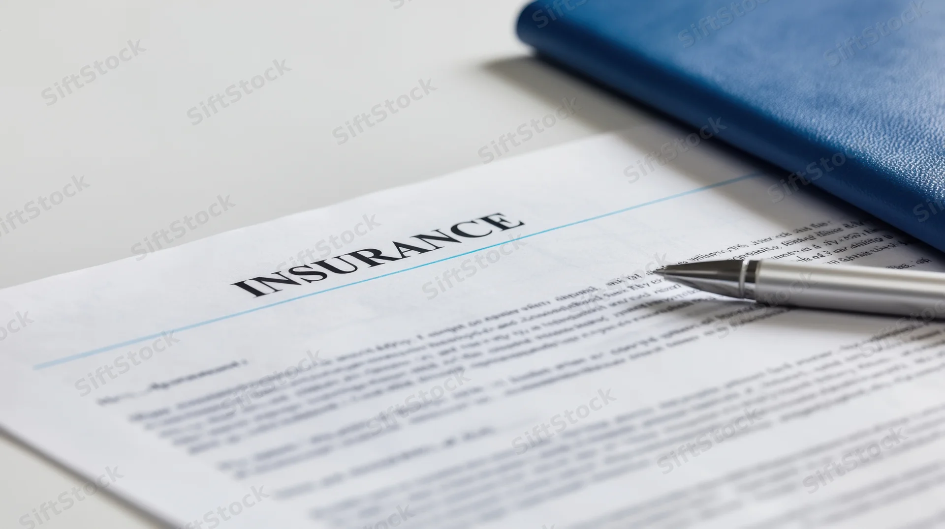 Insurance document with pen resting on it on a desk