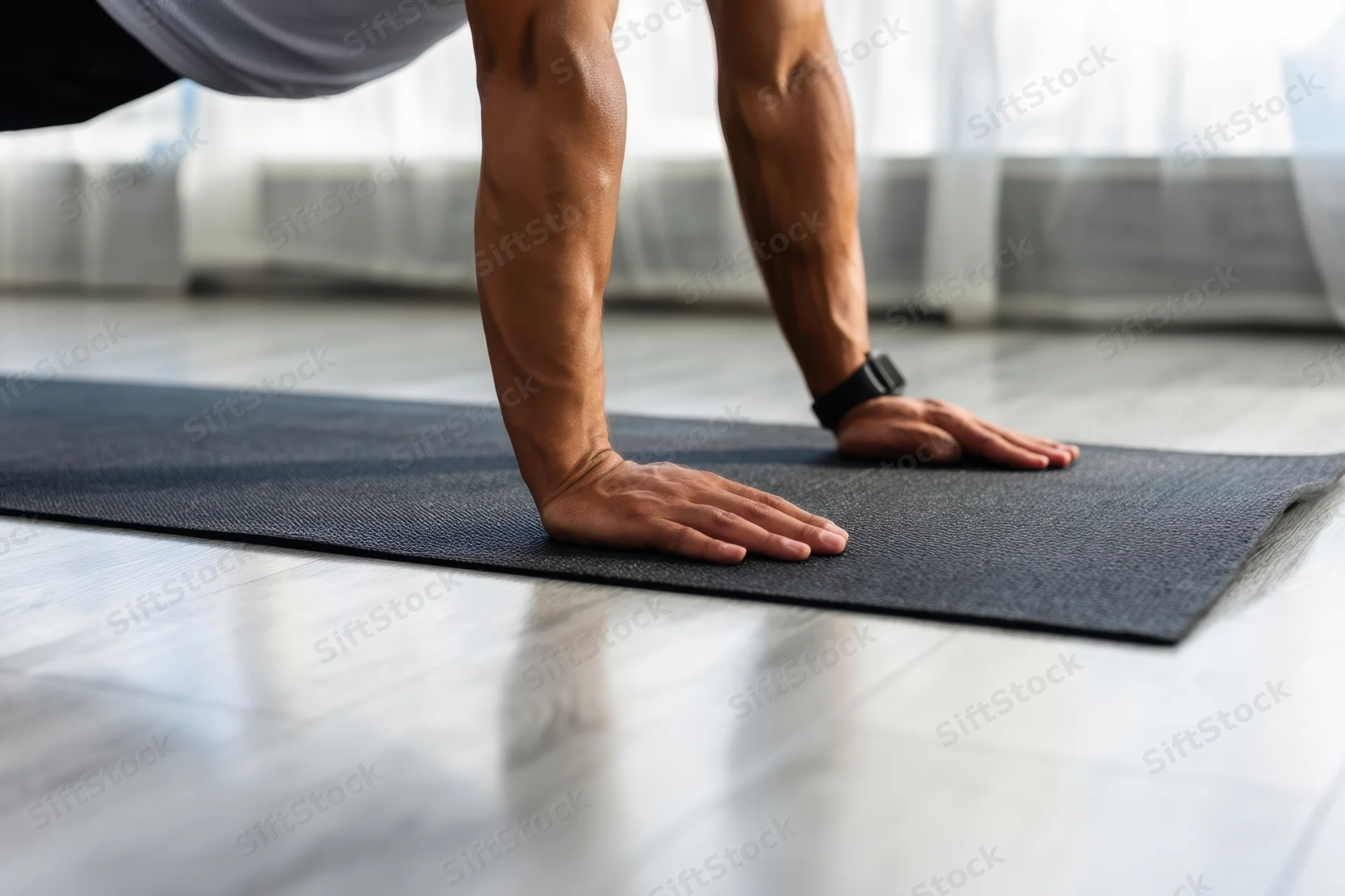 Man doing pushup on exercise mat indoors