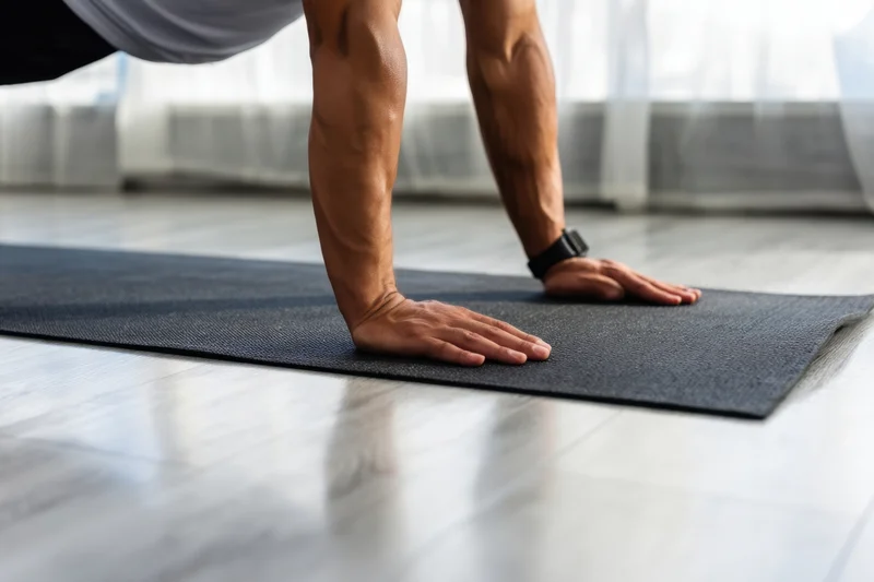 Man doing pushup on exercise mat indoors