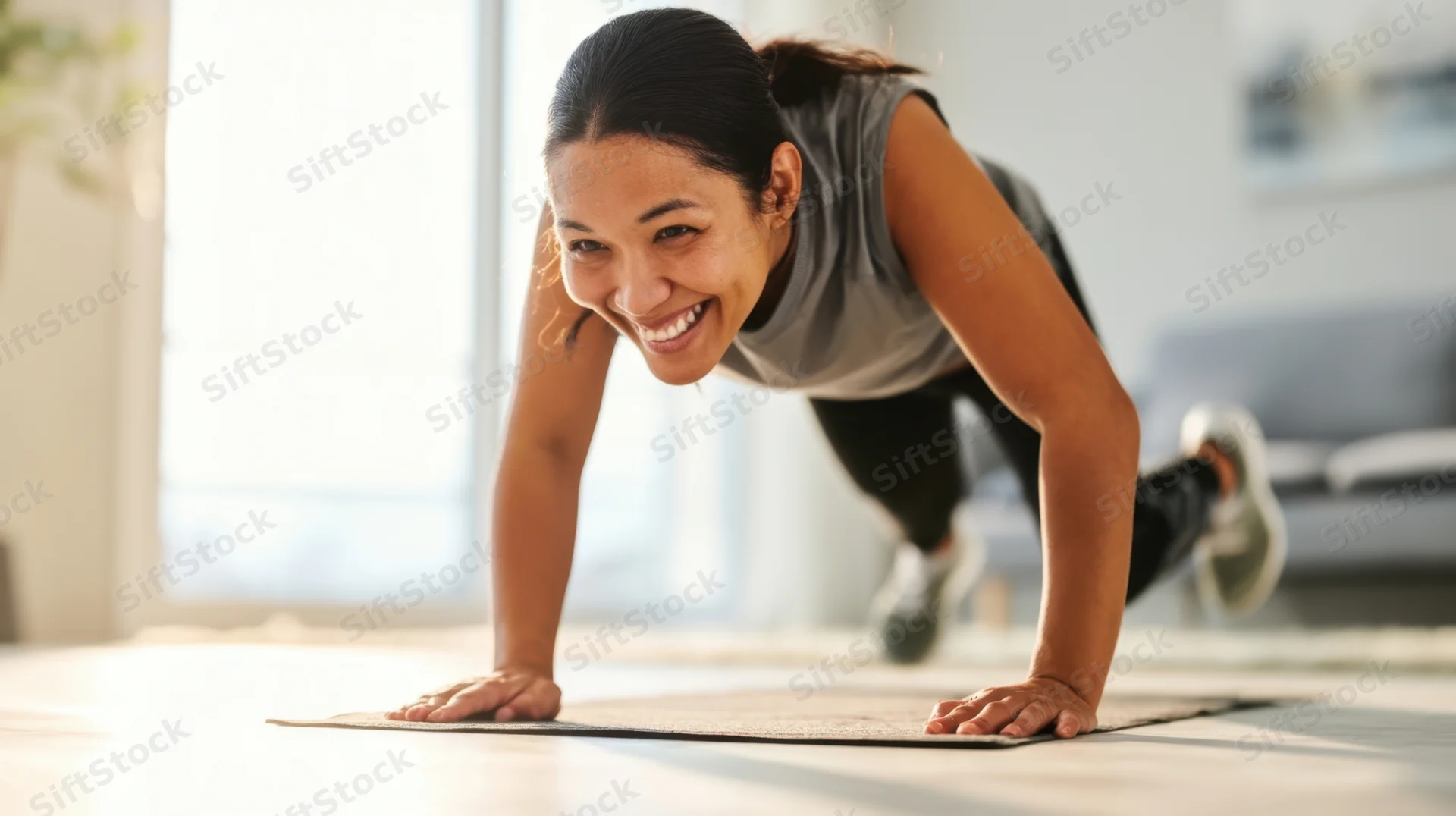 Woman doing pushup on mat in living room smiling