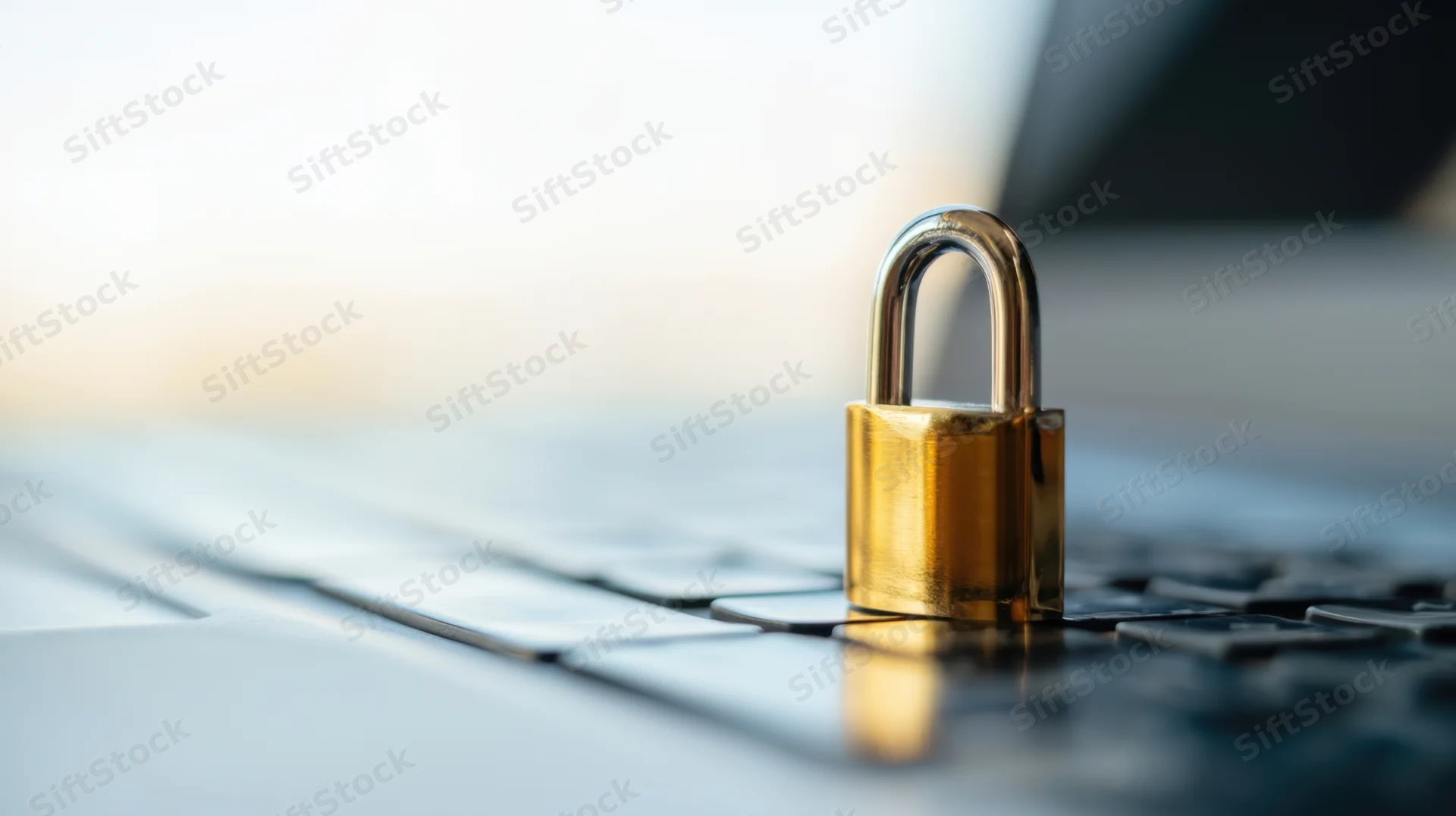 Golden padlock resting on laptop keyboard symbolizing digital security