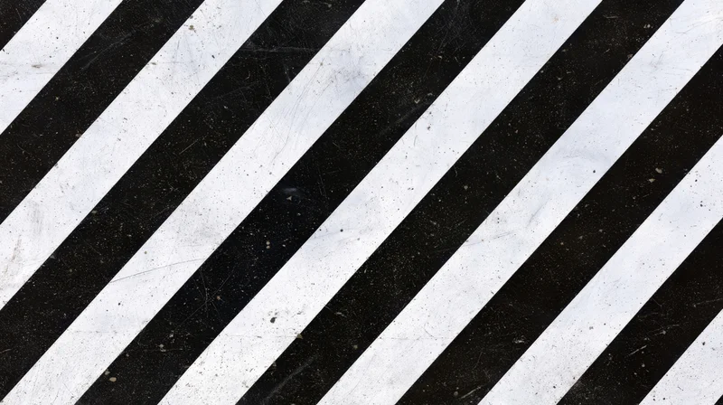 Diagonal black and white stripes on a worn textured surface
