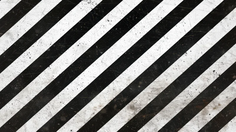 Diagonal black and white stripes with grunge texture covering the frame