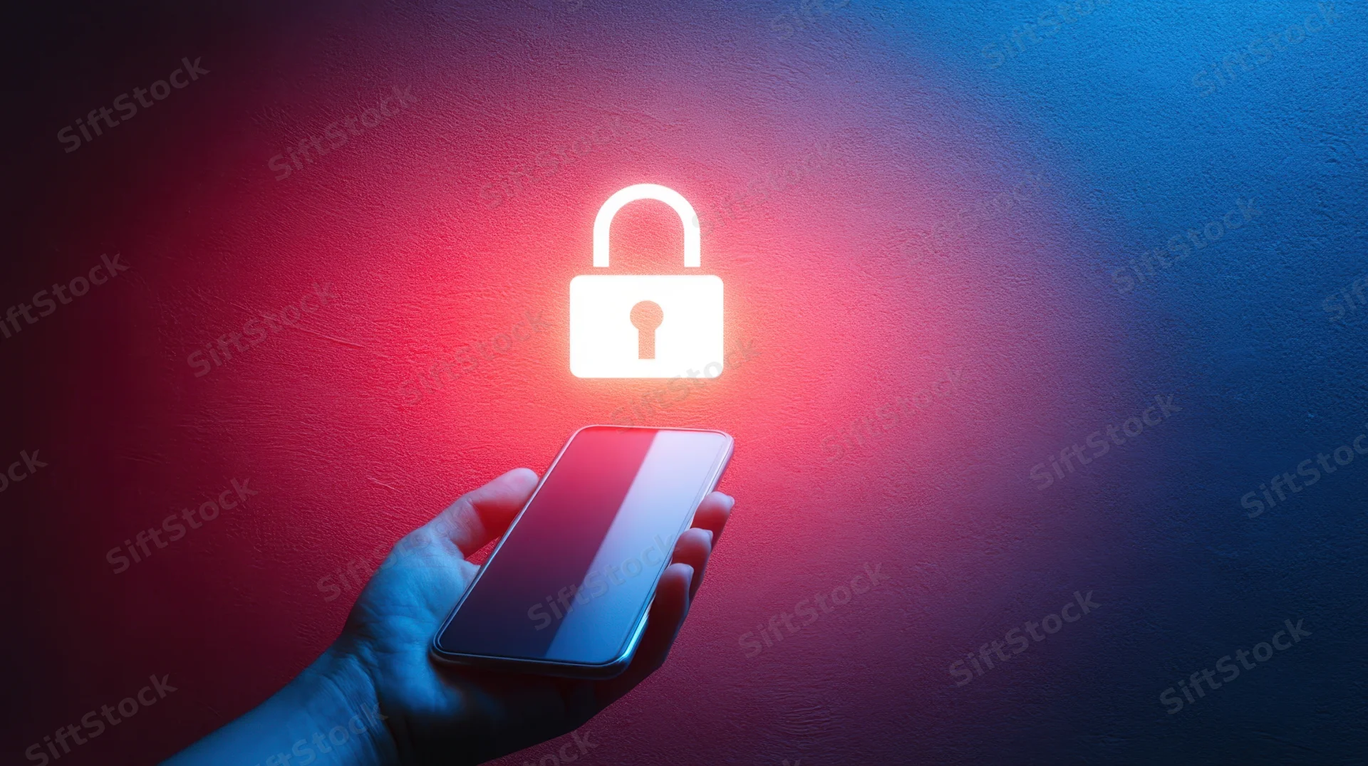 Hand holding smartphone with glowing digital lock above it against red and blue lit wall