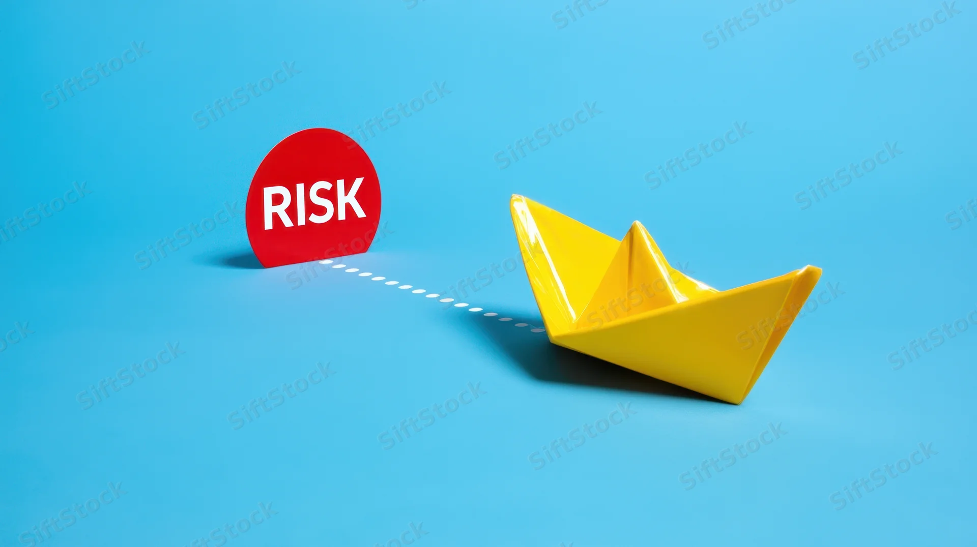 Yellow paper boat on blue surface connected by dotted line to red risk sign