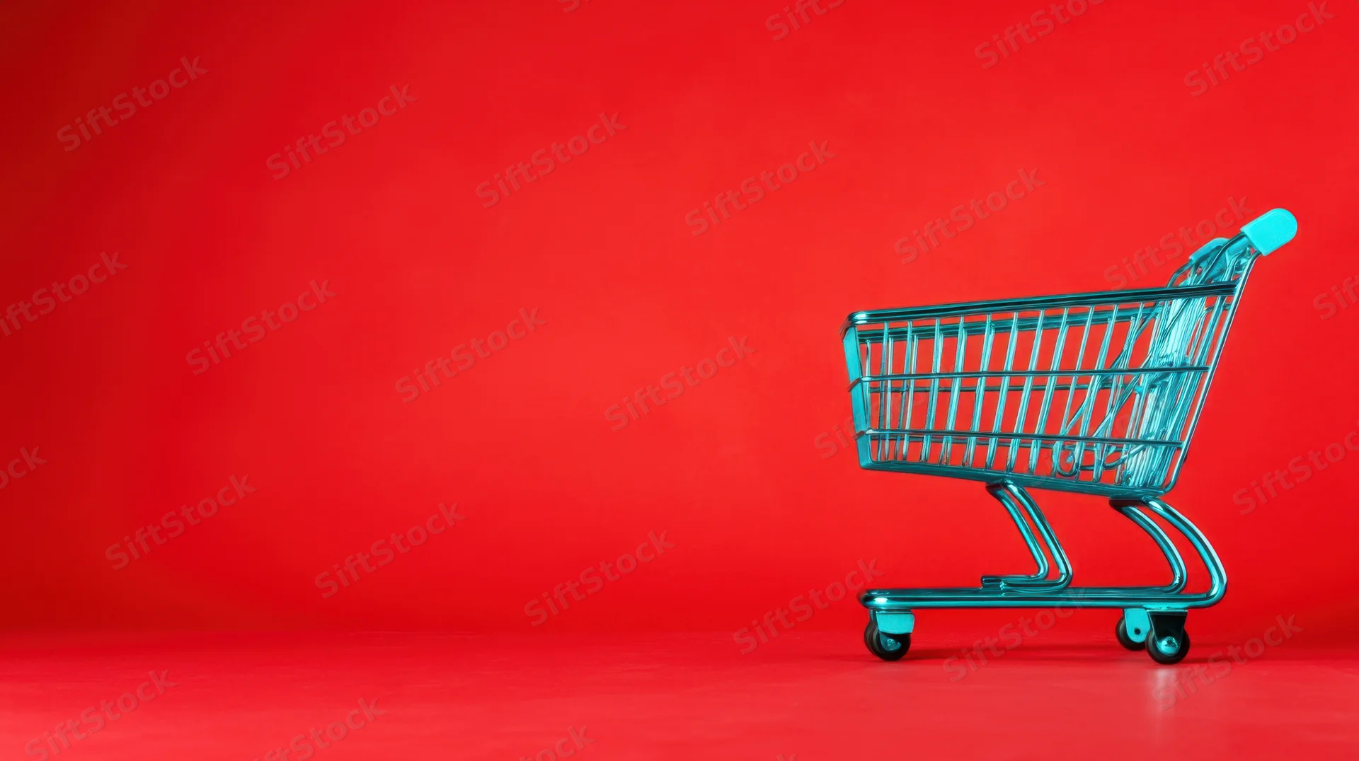A teal shopping cart on a red background with copyspace for text or logo