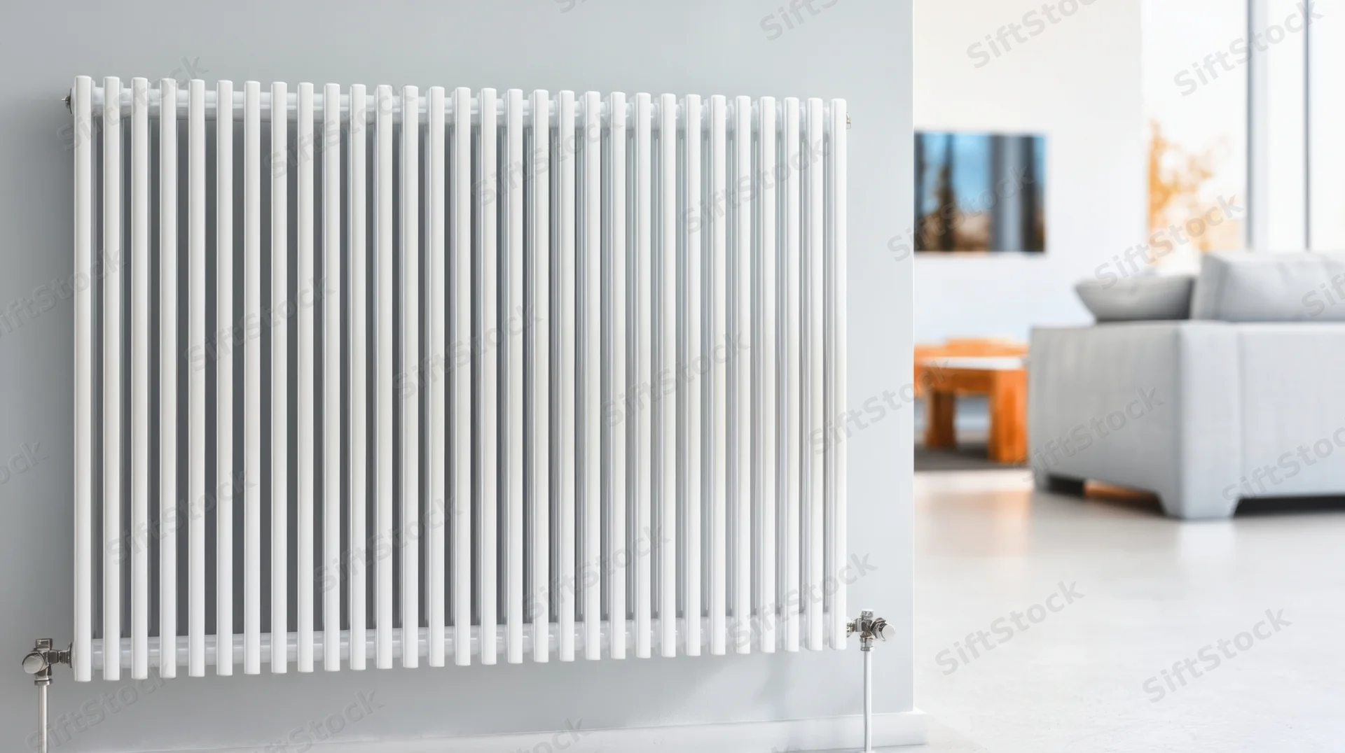 White vertical radiator mounted on a gray wall in a modern living room
