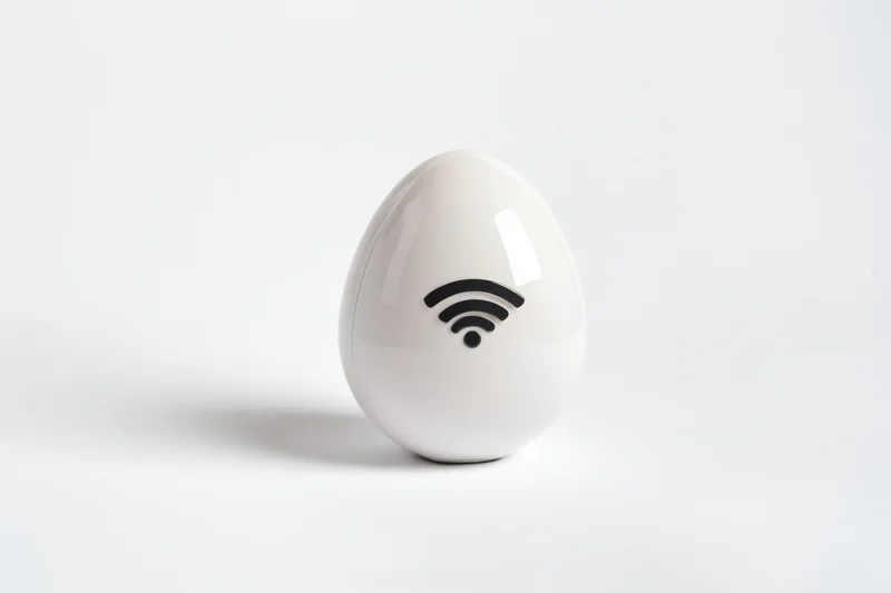White glossy egg with wi-fi symbol on plain white surface