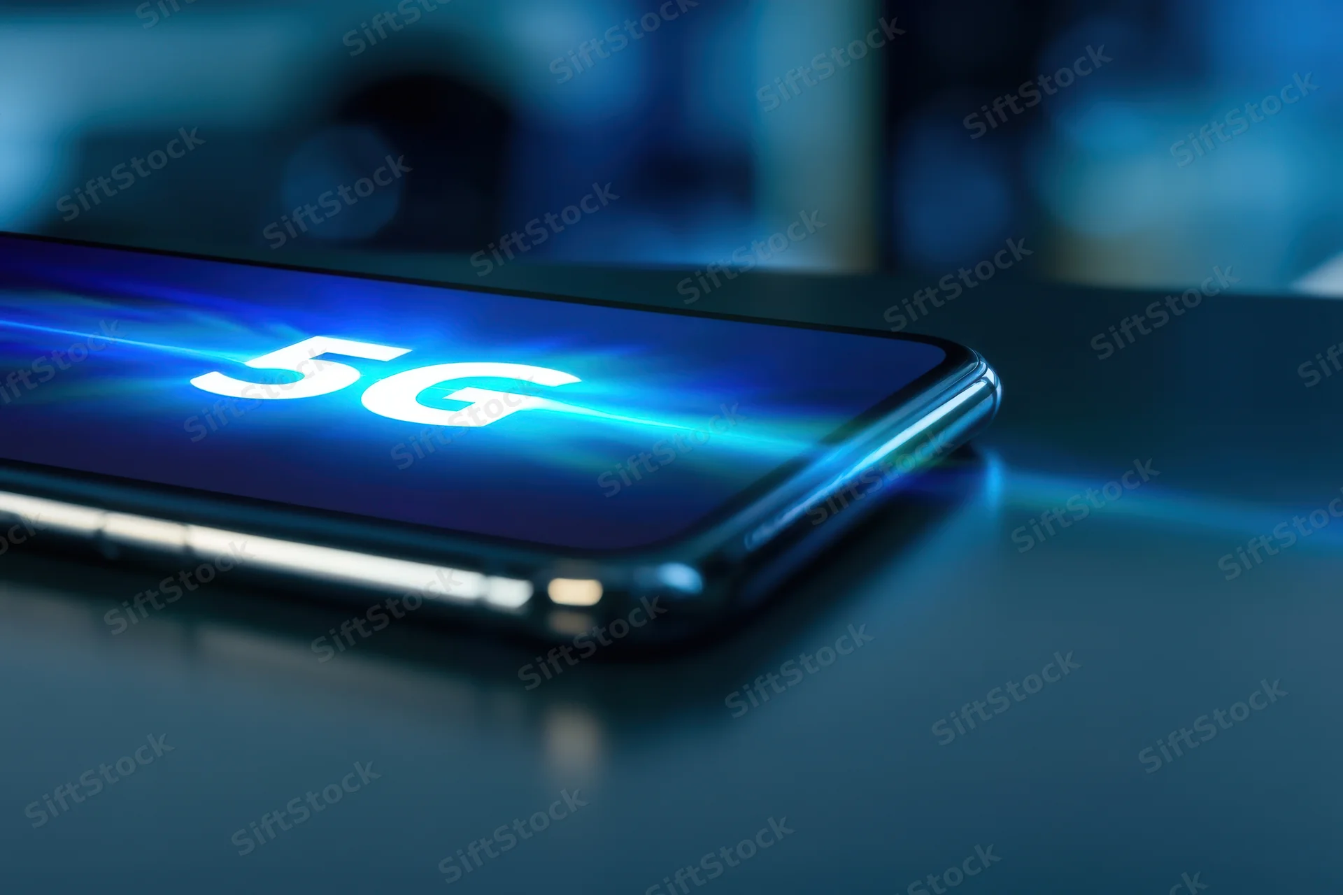 Smartphone displaying 5g text on screen with blue light effects on dark surface