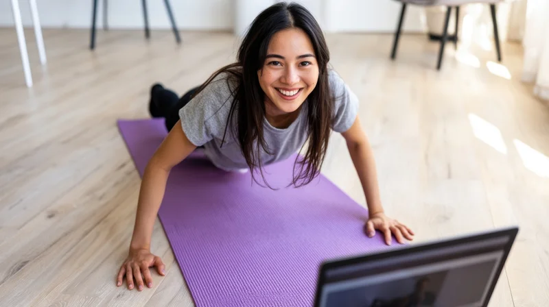 Woman doing plank exercise on purple mat in front of laptop at home