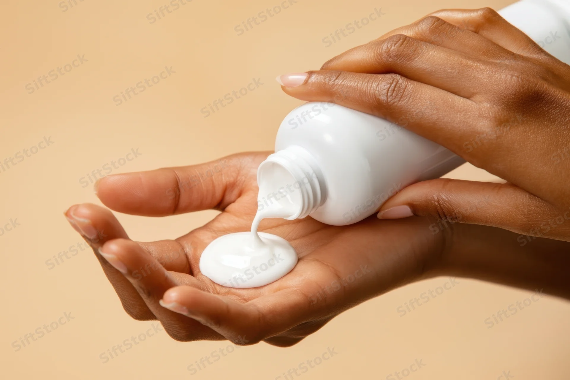 Woman squeezing white cream from bottle into her hand