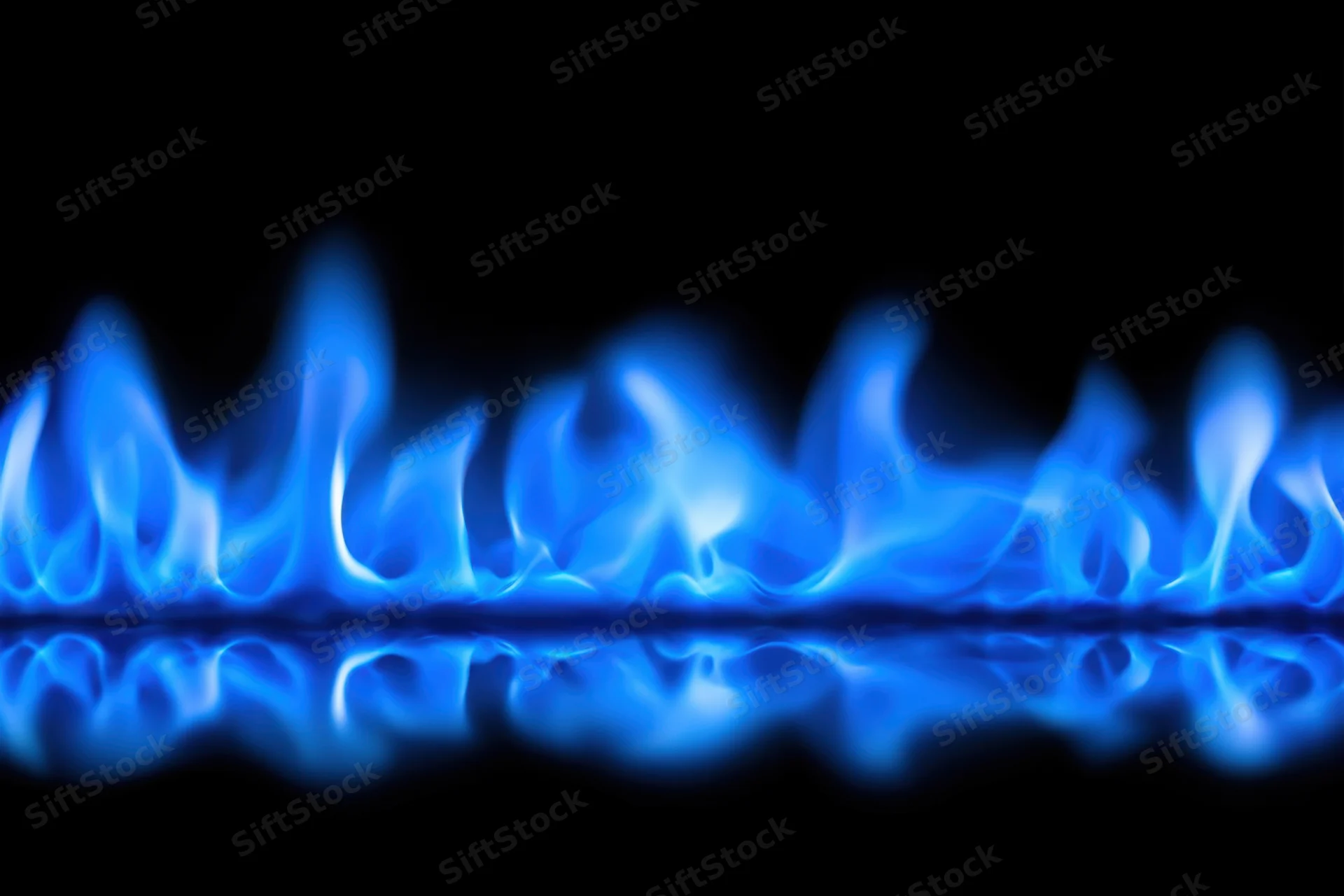 Blue flames burning along a reflective surface against a black background