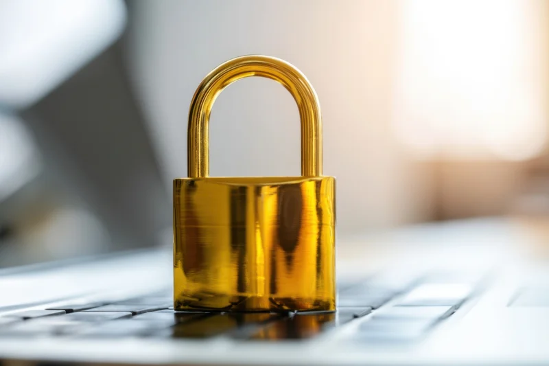 Golden padlock resting on laptop keyboard symbolizing digital security