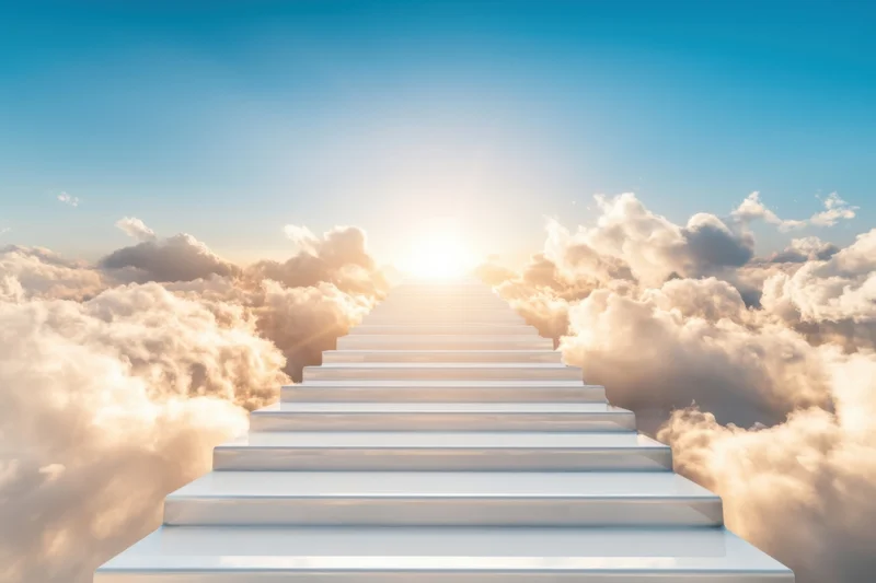 White staircase ascending through clouds toward sunrise sky