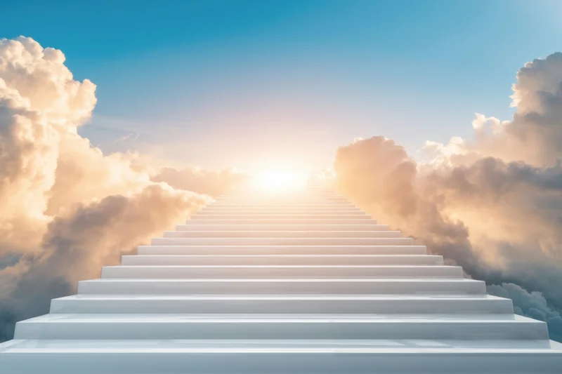 White staircase ascending through clouds toward a glowing sun in the sky